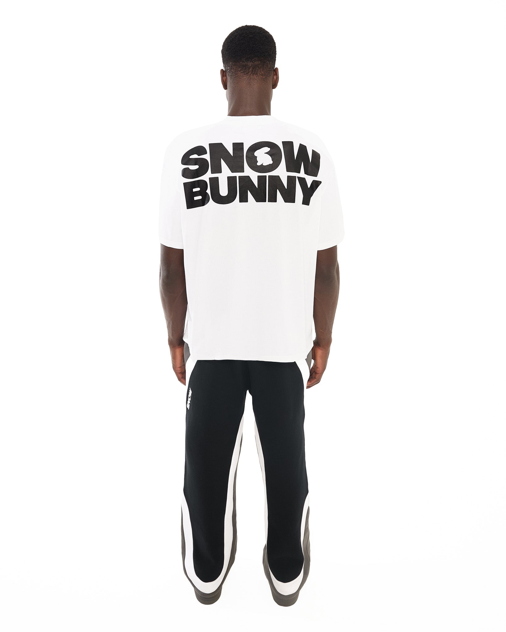 Back view of male model wearing Snow Bunny Oversized Tee in White