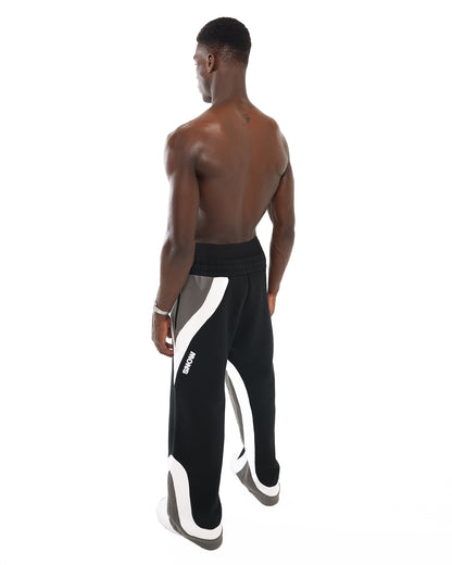 Side view of male model wearing Snow Bunny sweatpants